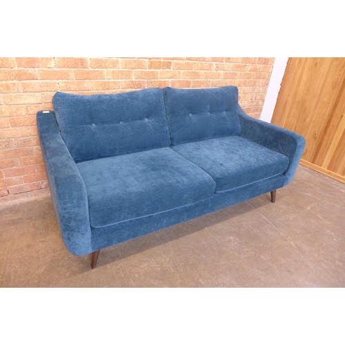 22 - A teal velvet buttoned back three seater sofa, small tear (H=90cm x W=190cm x D=90cm)