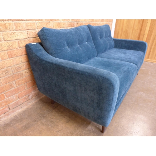 22 - A teal velvet buttoned back three seater sofa, small tear (H=90cm x W=190cm x D=90cm)