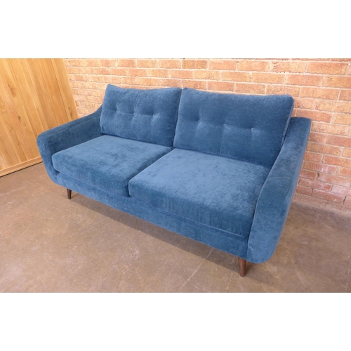 22 - A teal velvet buttoned back three seater sofa, small tear (H=90cm x W=190cm x D=90cm)