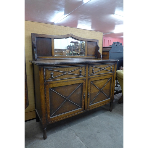 212 - An early 20th Century oak mirrorback sideboard