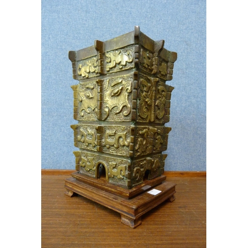 381 - An early 20th Century Chinese bronze lamp base, on carved hardwood stand