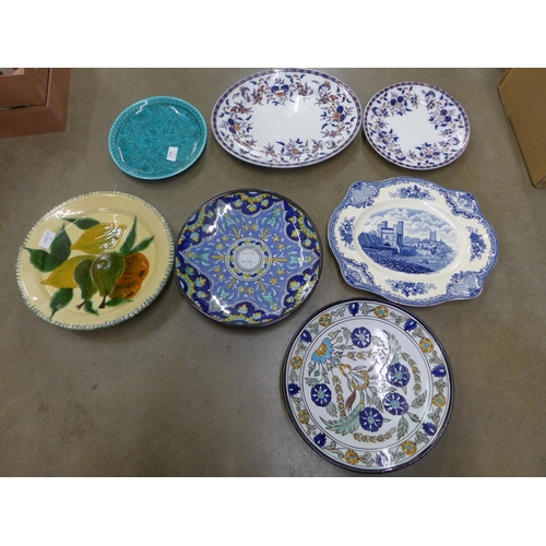 1129 - Four continental pottery chargers/bowls, a blue and white dish with early Canterbury scene and two p... 