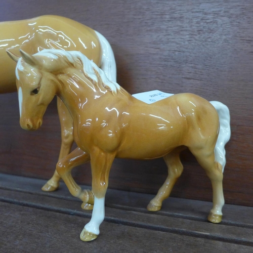 611 - A large Beswick palomino horse and one other smaller, chip to ear on smaller horse