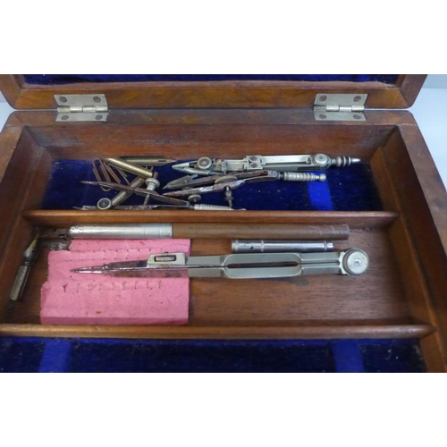 657 - A 19th Century walnut cased set of drawing instruments