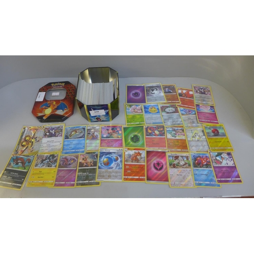 658 - 30 Reverse holo & 300 rare/uncommon and common Pokemon cards in tin