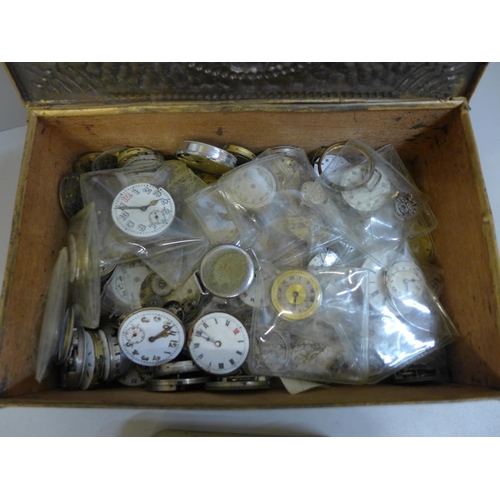 659 - A tin of early 20th Century trench watch movements