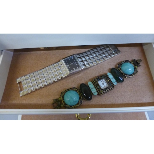 669 - A jewellery box with costume jewellery and wristwatches