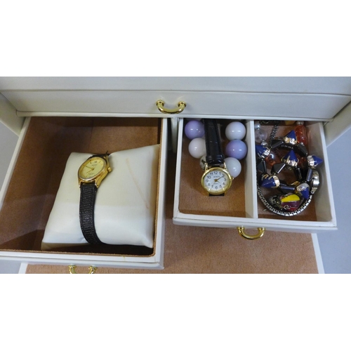 669 - A jewellery box with costume jewellery and wristwatches