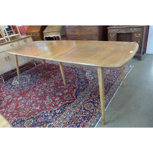 12 - An Ercol Blonde elm and beech Grand Windsor extending dining table