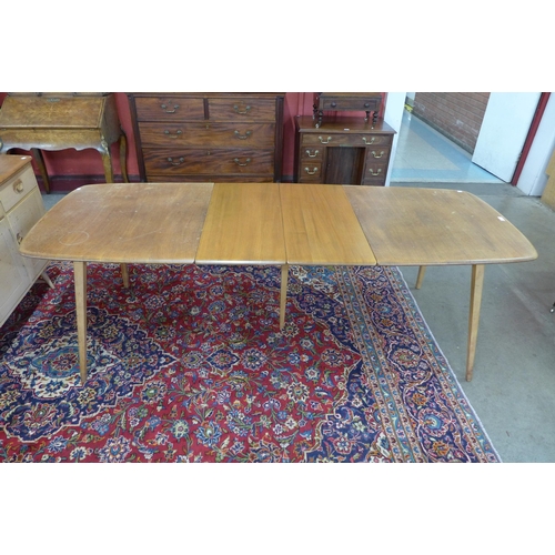 12 - An Ercol Blonde elm and beech Grand Windsor extending dining table