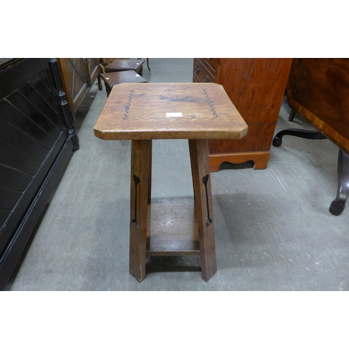 121 - An Arts and Crafts inlaid oak occasional table