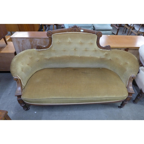 123 - A Victorian carved walnut and fabric upholstered settee