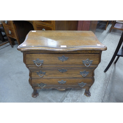 128 - A small French style oak bombe shaped commode