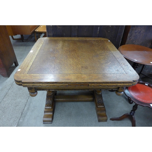 132 - A carved oak draw leaf table