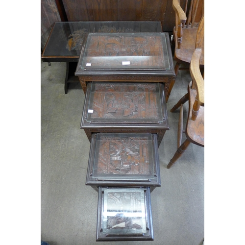 138 - An oriental carved hardwood nest of quartetto tables