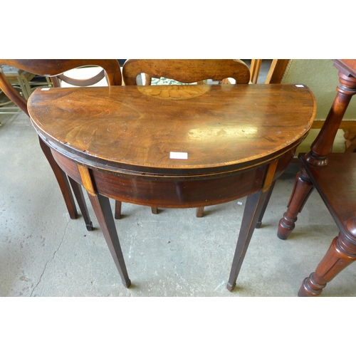 157 - A George III inlaid mahogany demi-lune fold over card table