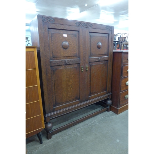 175 - An early 20th Century carved oak two door bookcase