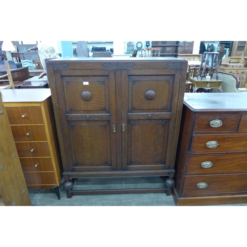 175 - An early 20th Century carved oak two door bookcase