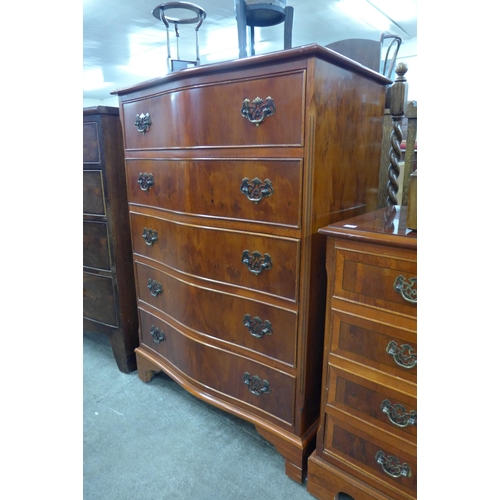 184 - A yew wood serpentine chest of drawers