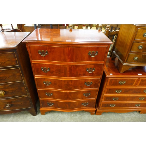 184 - A yew wood serpentine chest of drawers