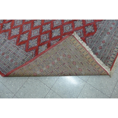 202 - An eastern red ground rug