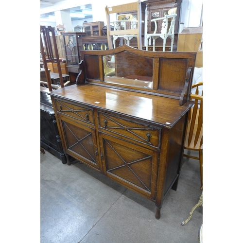 212 - An early 20th Century oak mirrorback sideboard