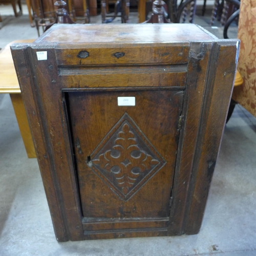 243 - A 17th Century carved oak single door wall hanging cupboard