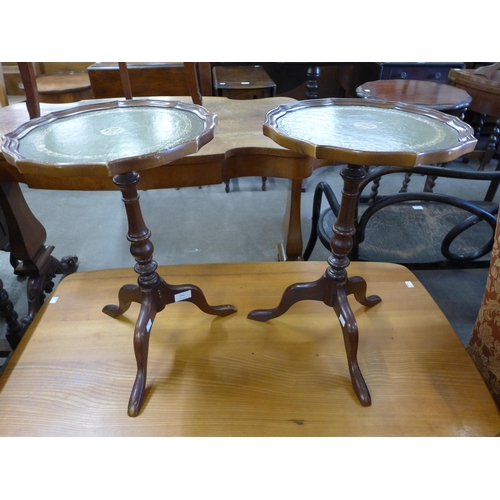 244 - A pair of mahogany and green leather topped tripod wine tables