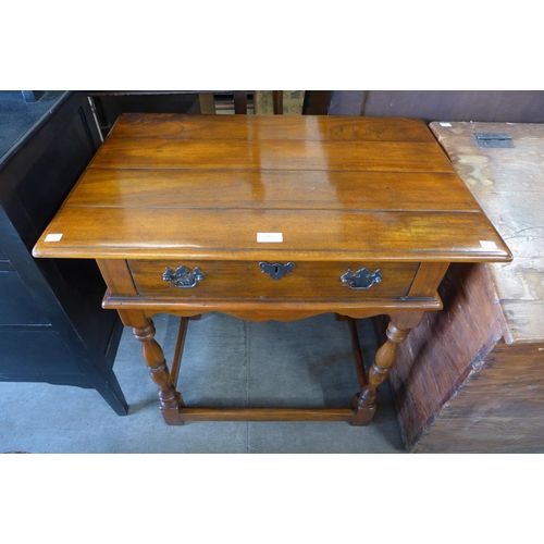 252 - An 18th Century style hardwood single drawer side table