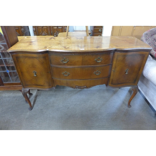 268 - A Queen Anne style Waring & Gillows walnut serpentine sideboard