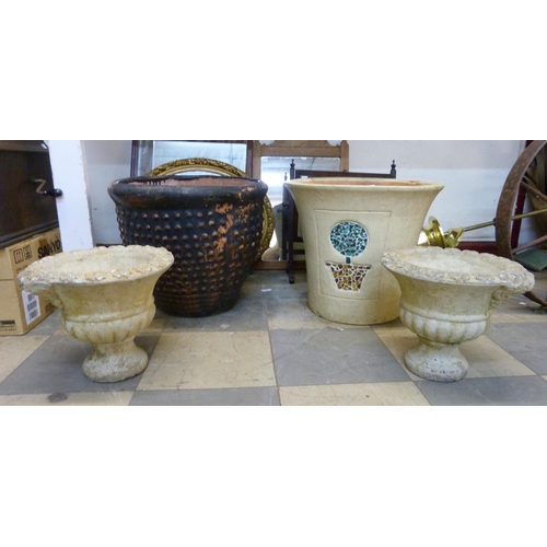 309 - A pair of small concrete campana shaped garden urns and two larger garden urns