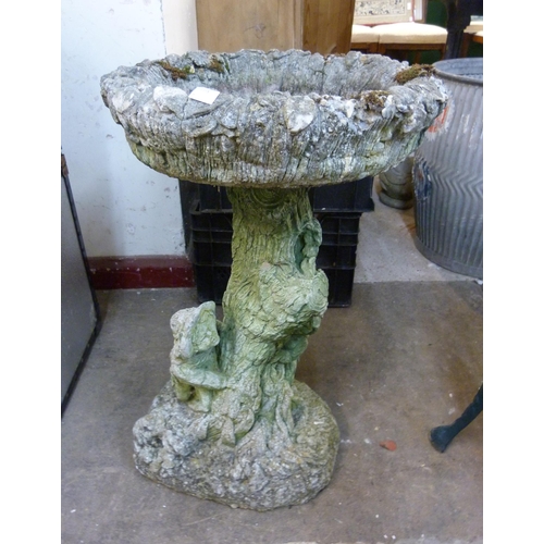 317 - A concrete figural garden bird bath