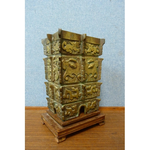 381 - An early 20th Century Chinese bronze lamp base, on carved hardwood stand