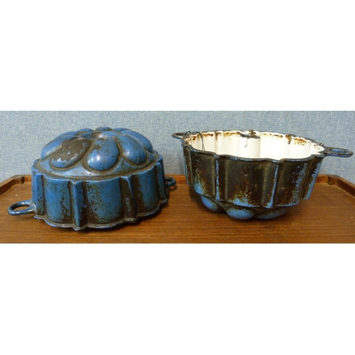 402 - A pair of enamelled cast iron jelly moulds