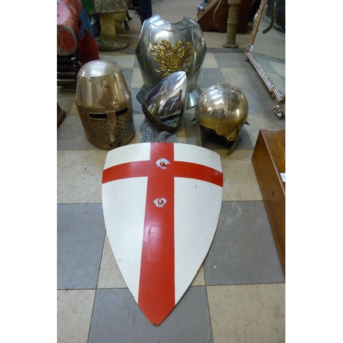 414 - Three medieval style helmets, a shield and a breast armour plate, re-enactment pieces