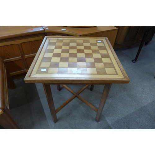 57 - A square inlaid teak games table