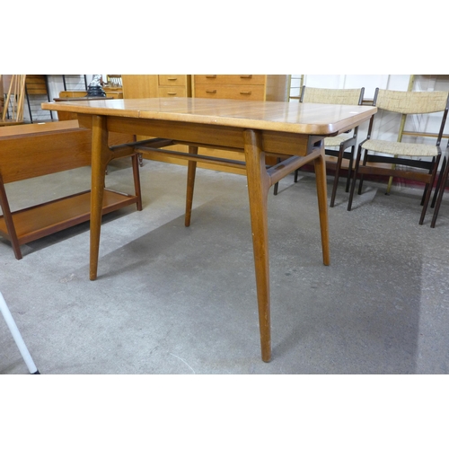 73 - An afromosia extending dining table