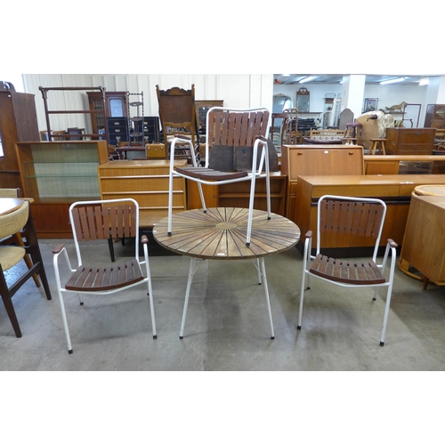 75 - A Danish Daneline teak and white tubular steel garden table and three chairs