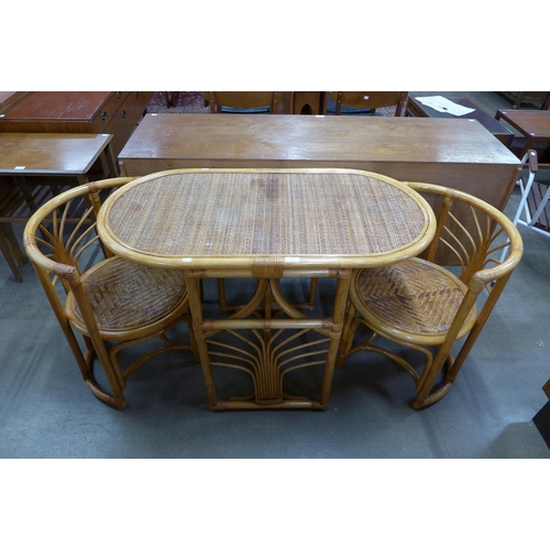 76 - A bamboo and rattan table and two chairs