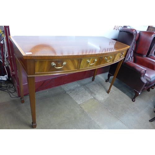 89 - A George III style inlaid mahogany bow front three drawer serving table