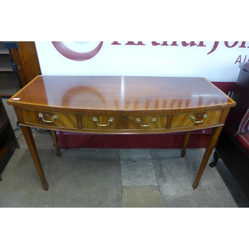 89 - A George III style inlaid mahogany bow front three drawer serving table