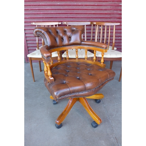 97A - A mahogany brown leather revolving Captains desk chair