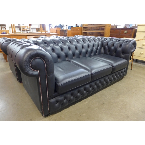 98 - A black leather Chesterfield settee