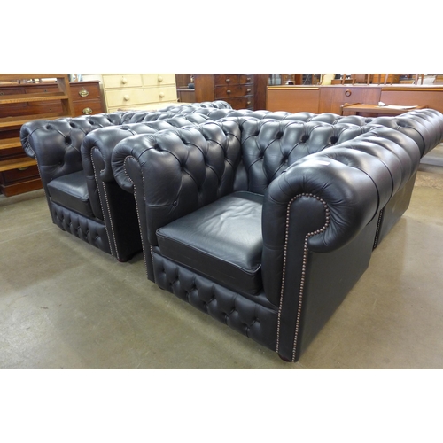 99 - A pair of black leather Chesterfield club chairs