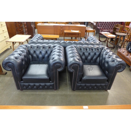 99 - A pair of black leather Chesterfield club chairs