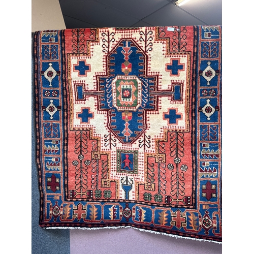 1514 - A terracotta ground, full pile, hand woven Persian rug, 172cm x 112cm