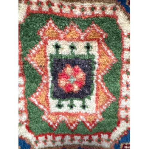 1514 - A terracotta ground, full pile, hand woven Persian rug, 172cm x 112cm