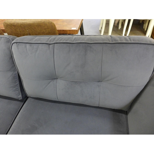 1467 - A slate pinched back velvet three seater sofa