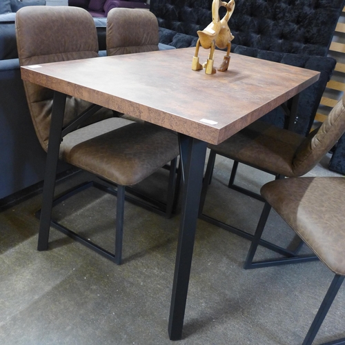 1472 - A copper effect top dining table with a set of four Mezan brown upholstered dining chairs