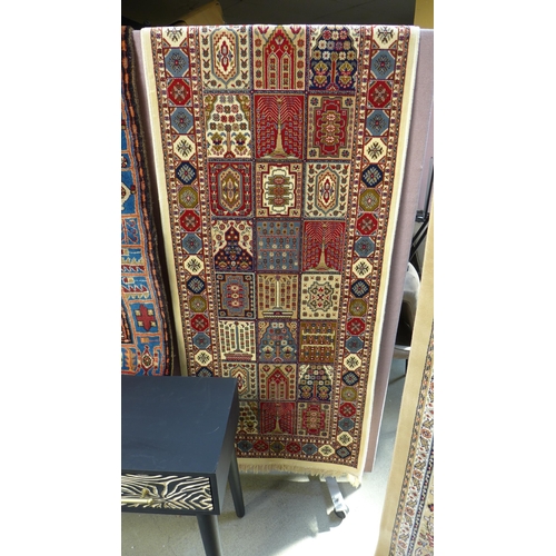 1515 - An ivory ground Cashmere runner, with Persian panel design, 300 x 80cm